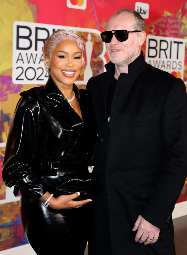 Eve in a sleek dark leather outfit and Maximillion Cooper in a dark coat and sunglasses at the 2022 Brit Awards
