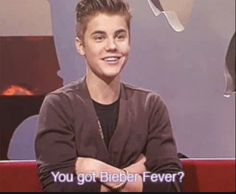 Justin Bieber smiling with crossed arms