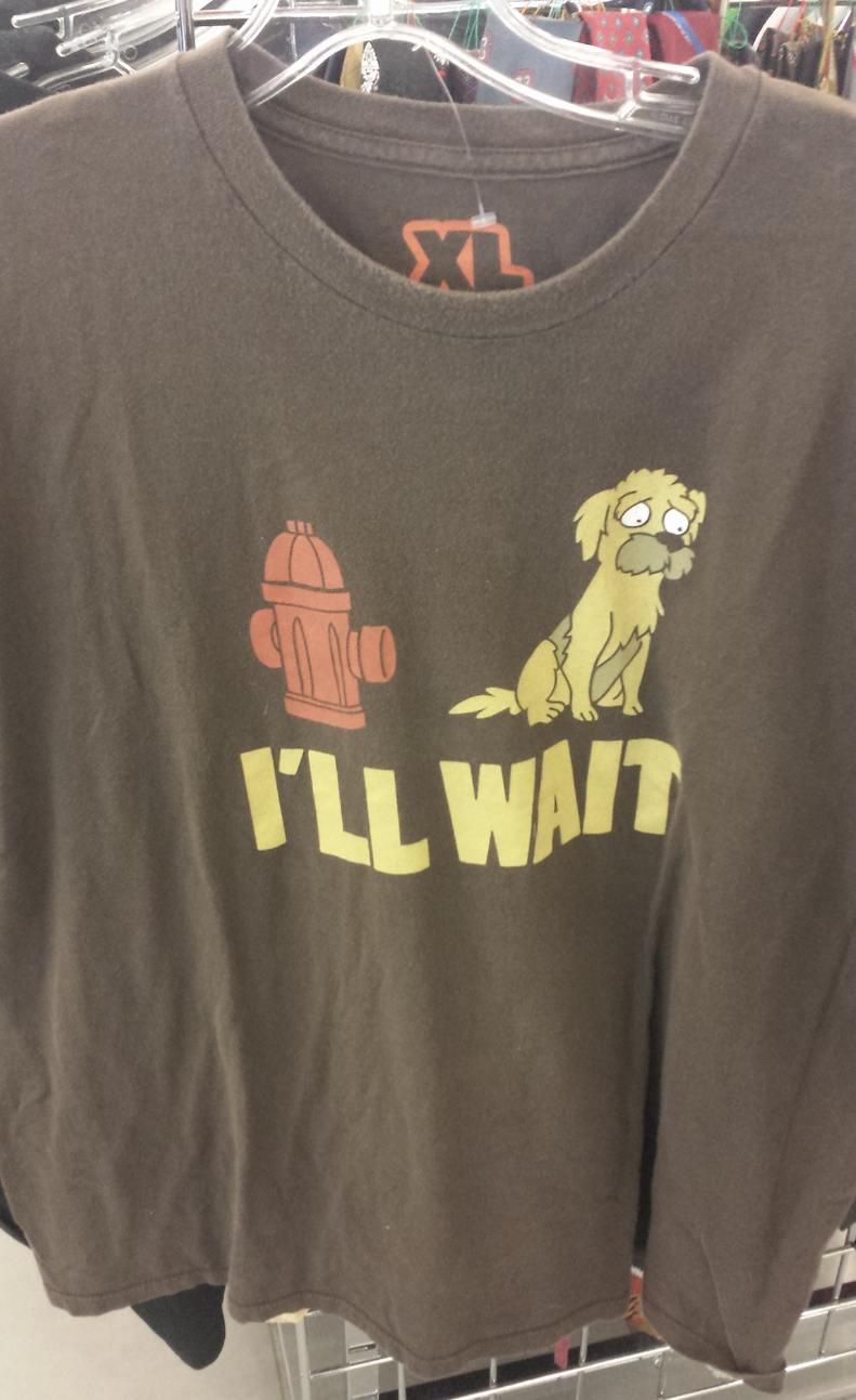 T-shirt with a cartoon of a sad dog sitting beside a fire hydrant and the text "I'LL WAIT" below the illustration