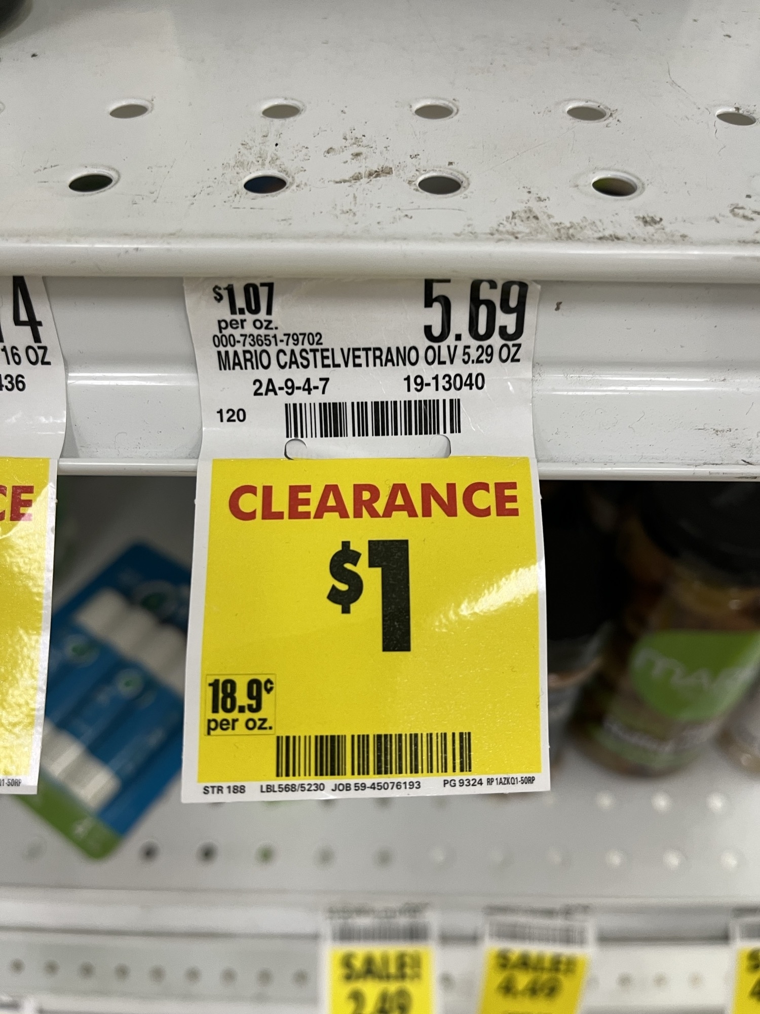 Store shelf with "Clearance $1" sign for Mario Castelvetrano Olives, originally $5.69