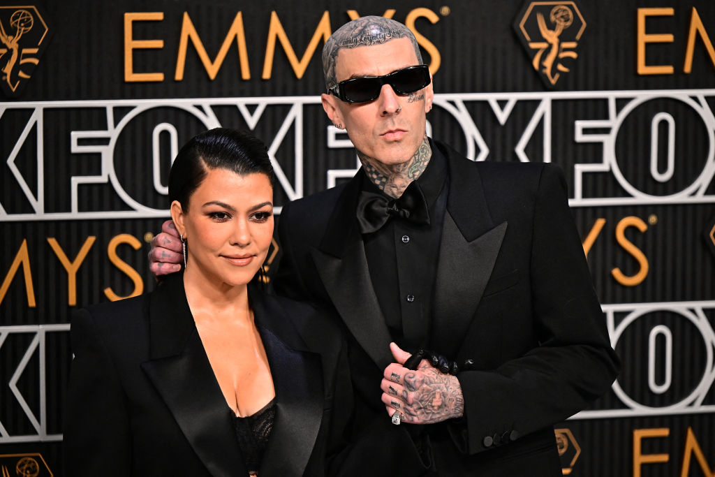 Kourtney Kardashian and Travis Barker pose on the Emmy's red carpet