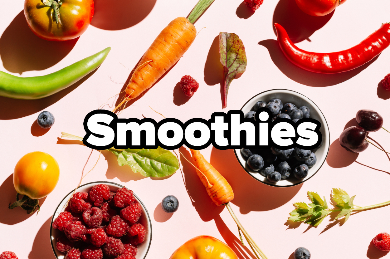 Various fruits and vegetables, including tomatoes, carrots, peppers, raspberries, blueberries, cherries, and green beans, arranged with the word "Smoothies" in the center