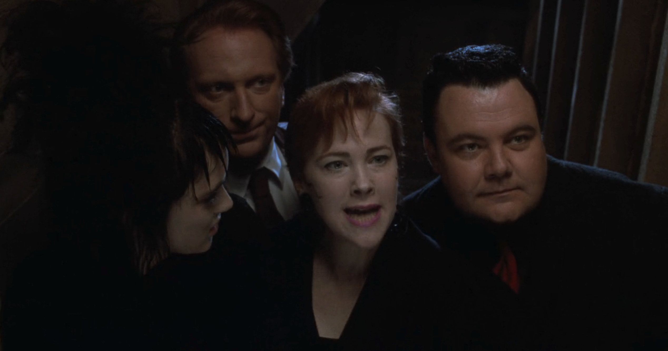 Winona Ryder, Catherine O'Hara, Jeffrey Jones, and Glenn Shadix are close together, appearing to be engaged in a conversation or scene