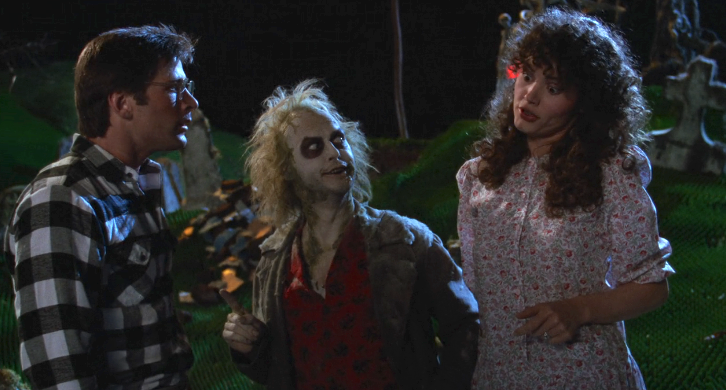 A scene from Beetlejuice featuring the characters Adam Maitland, Beetlejuice, and Barbara Maitland in conversation