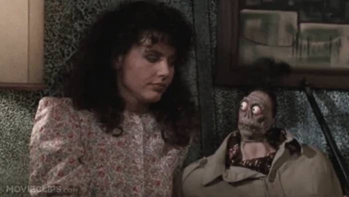 Geena Davis sits beside a decaying humanoid figure in a scene from "Beetlejuice."