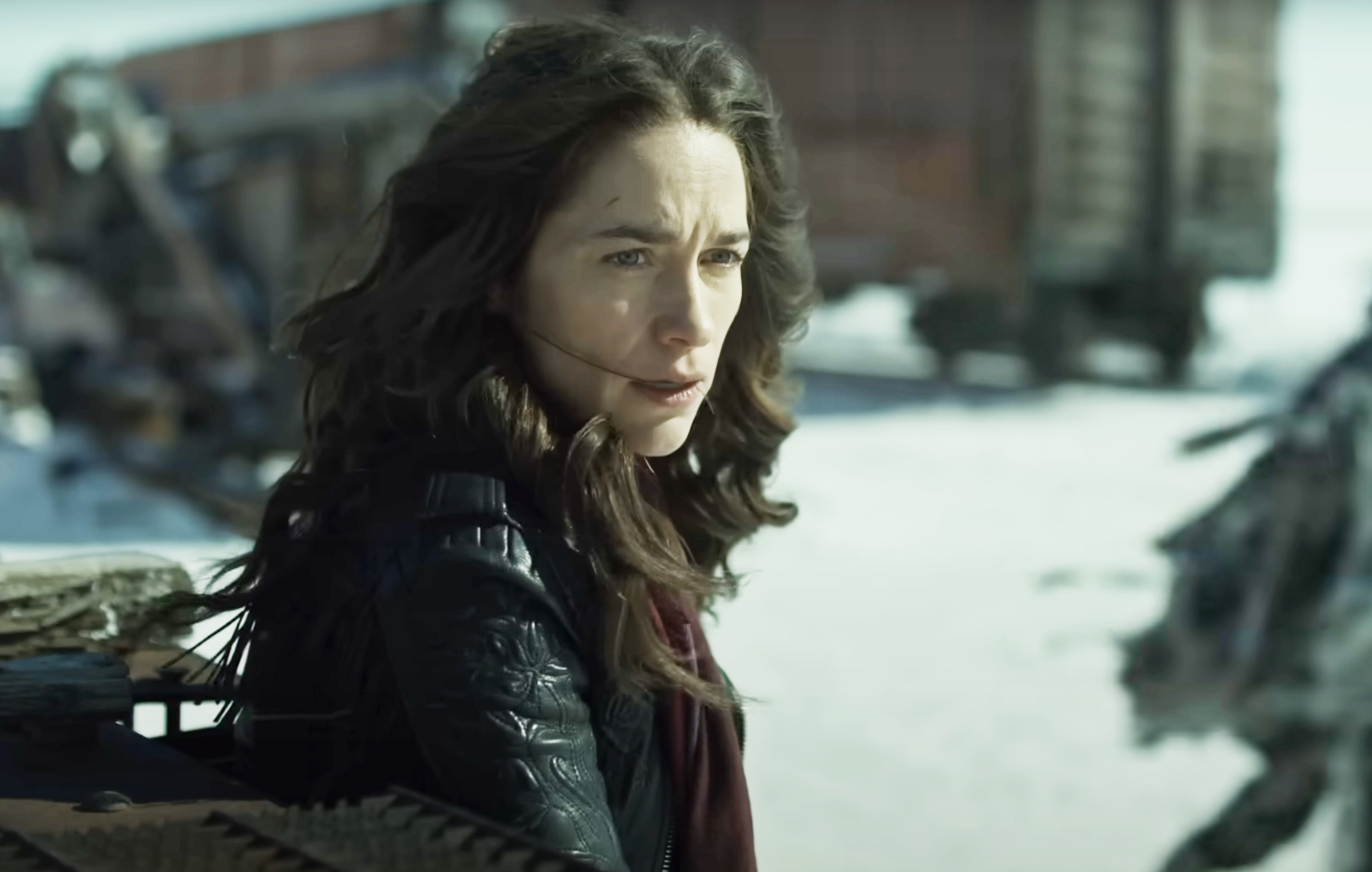 Melanie Scrofano as Wynonna Earp standing, looking concerned, surrounded by snow