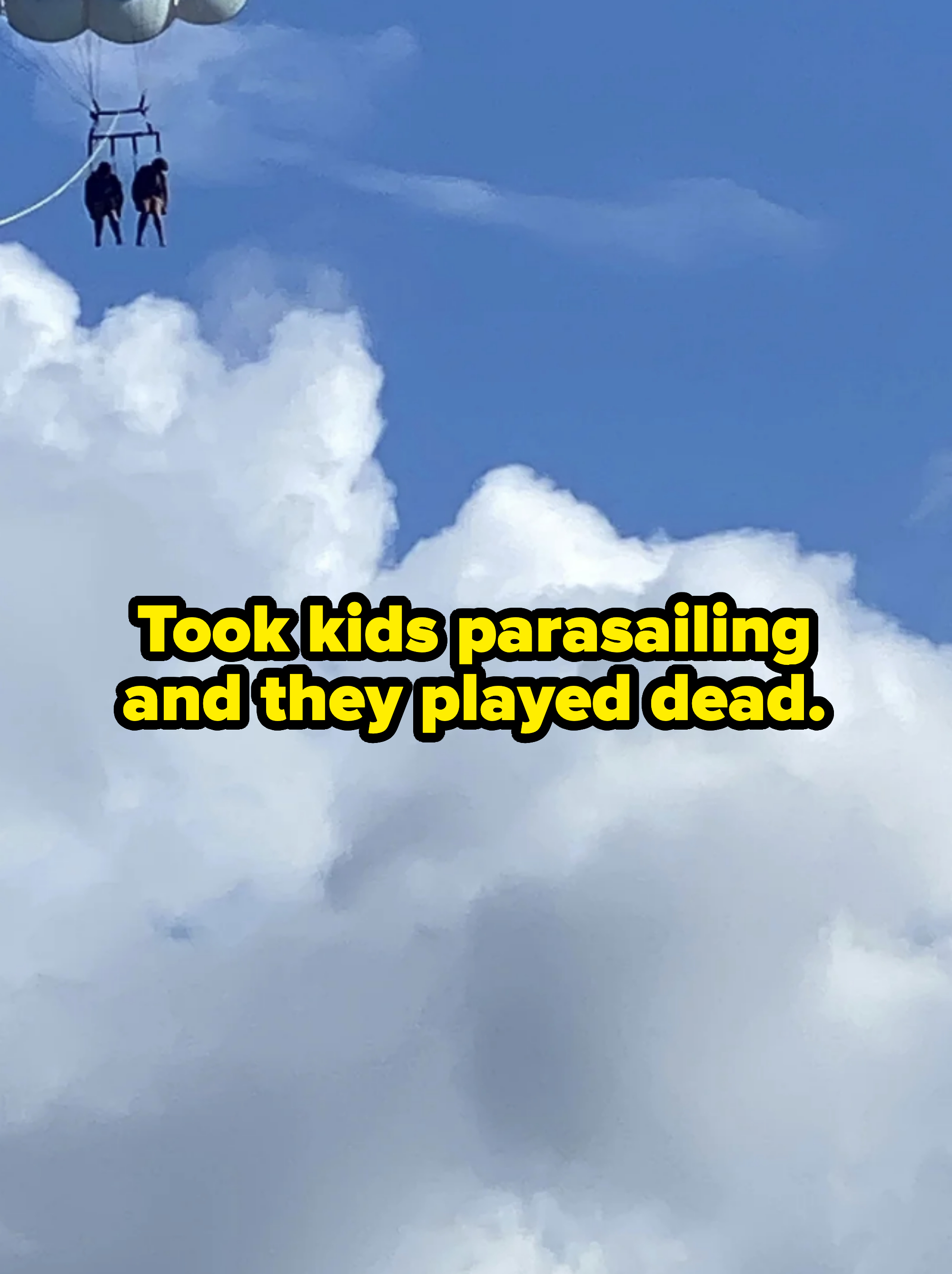 Two people parasailing, with their bodies limp, captioned "took kids parasailing and they played dead"