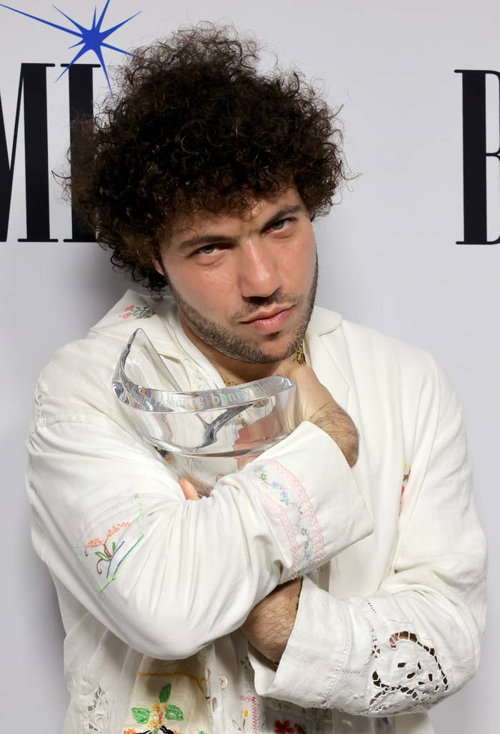 Benny Blanco posing with an award, wearing a white embroidered shirt at a BMI event