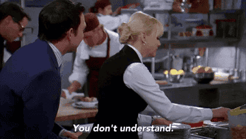 Anna Faris, in a waitress outfit, speaks animatedly to a man in a kitchen while chefs work in the background. Text on image: &quot;You don't understand.&quot;