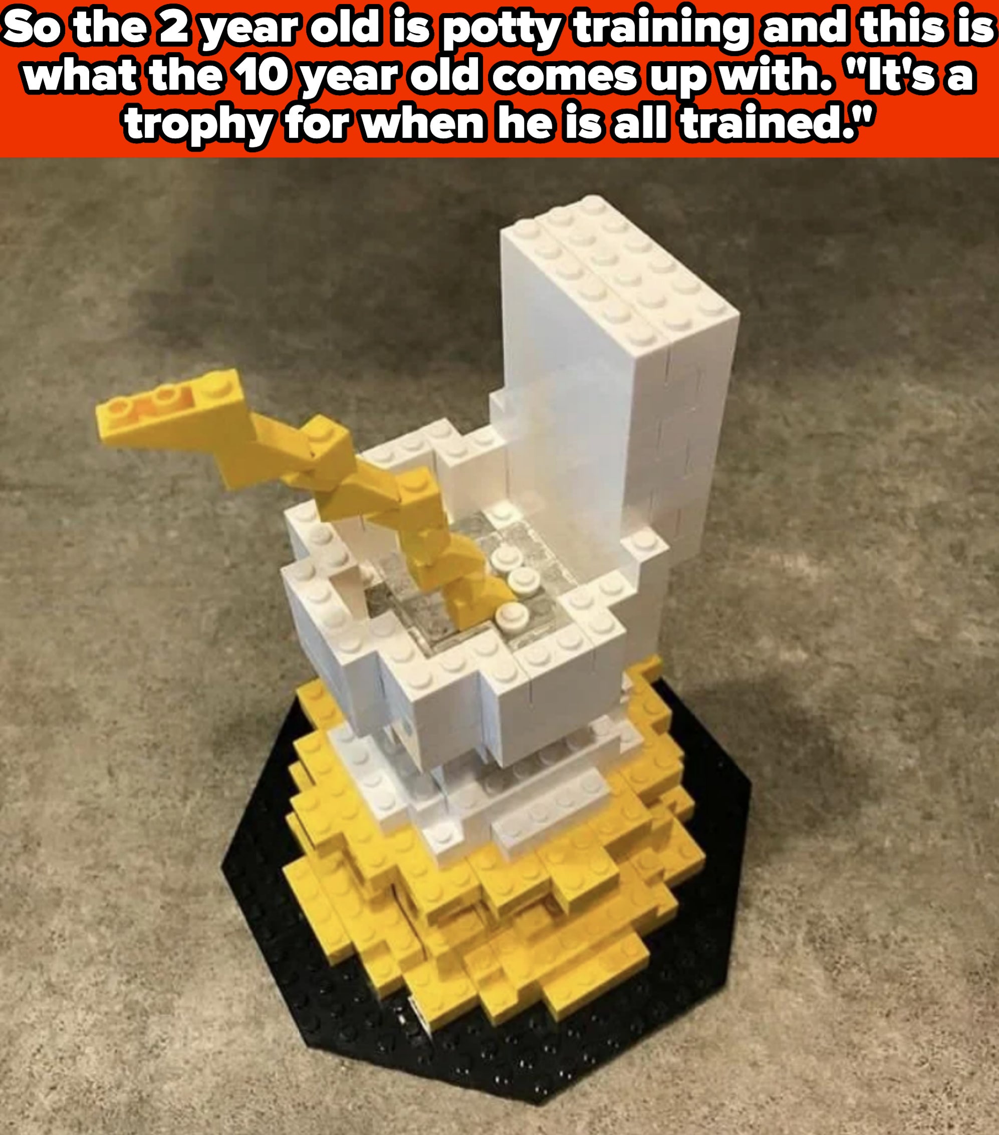 A Lego trophy made by a child, featuring a white toilet with a yellow Lego arm on top, symbolizing a reward for successful potty training. Text describes the image