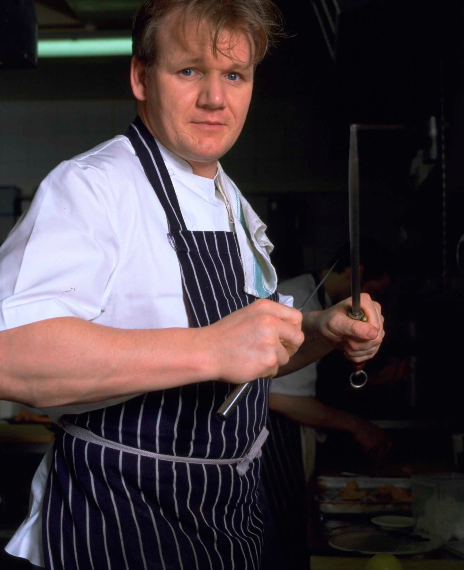 Young Gordon Ramsay in a kitchen cooking
