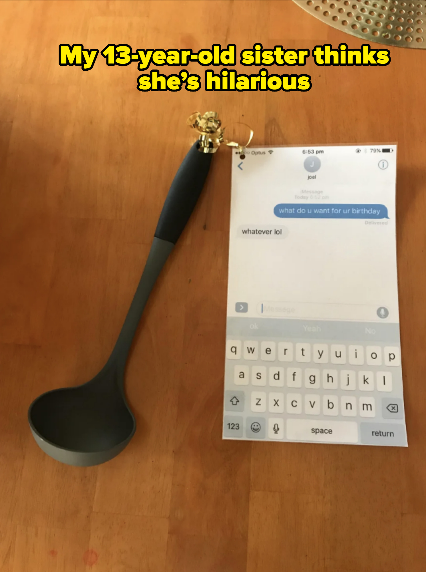 A ladle is placed next to a phone showing a text conversation where someone asks, "what do u want for ur birthday" and the reply is "whatever lol."