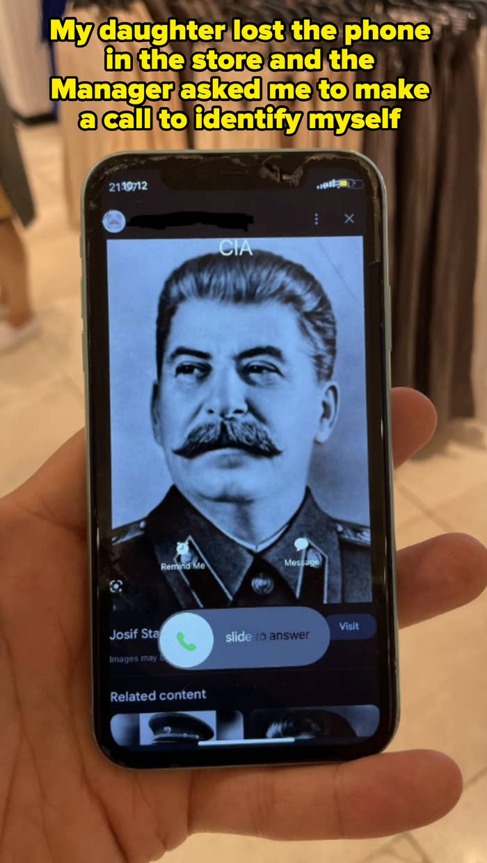 A hand holds a phone displaying a black-and-white photo of Joseph Stalin with a call screen open from the "CIA"