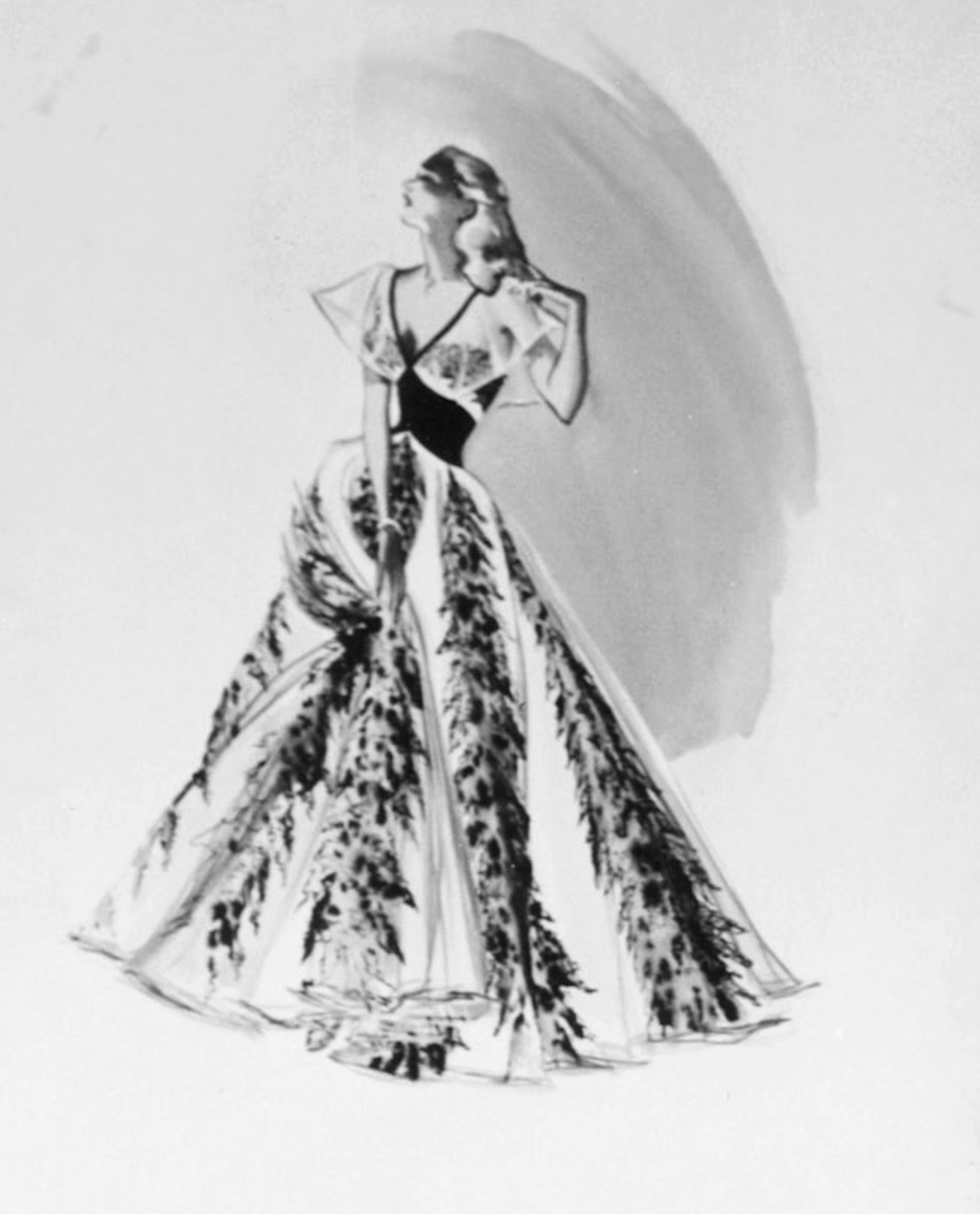 Sketch of a woman in a gown with flowing lines resembling leaves or branches. The outfit has an elegant, vintage style
