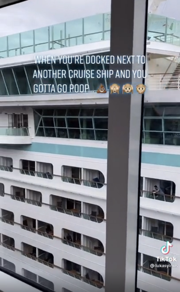 View from a window showing a docked cruise ship. Text reads, "WHEN YOU'RE DOCKED NEXT TO ANOTHER CRUISE SHIP AND YOU GOTTA GO POOP…?????."