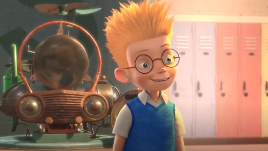 Lewis smiling with his invention behind him.