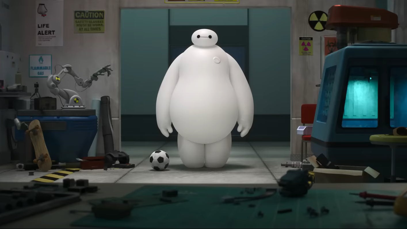 A picture of Baymax standing next to a soccer ball.