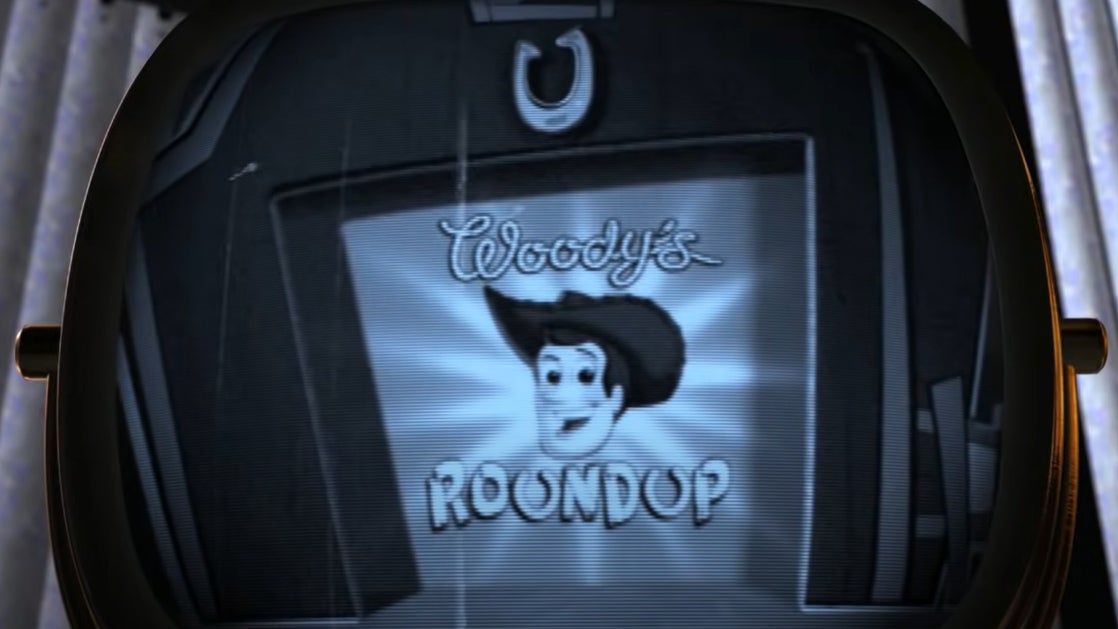A TV screen showing the opening of Woody's Roundup.