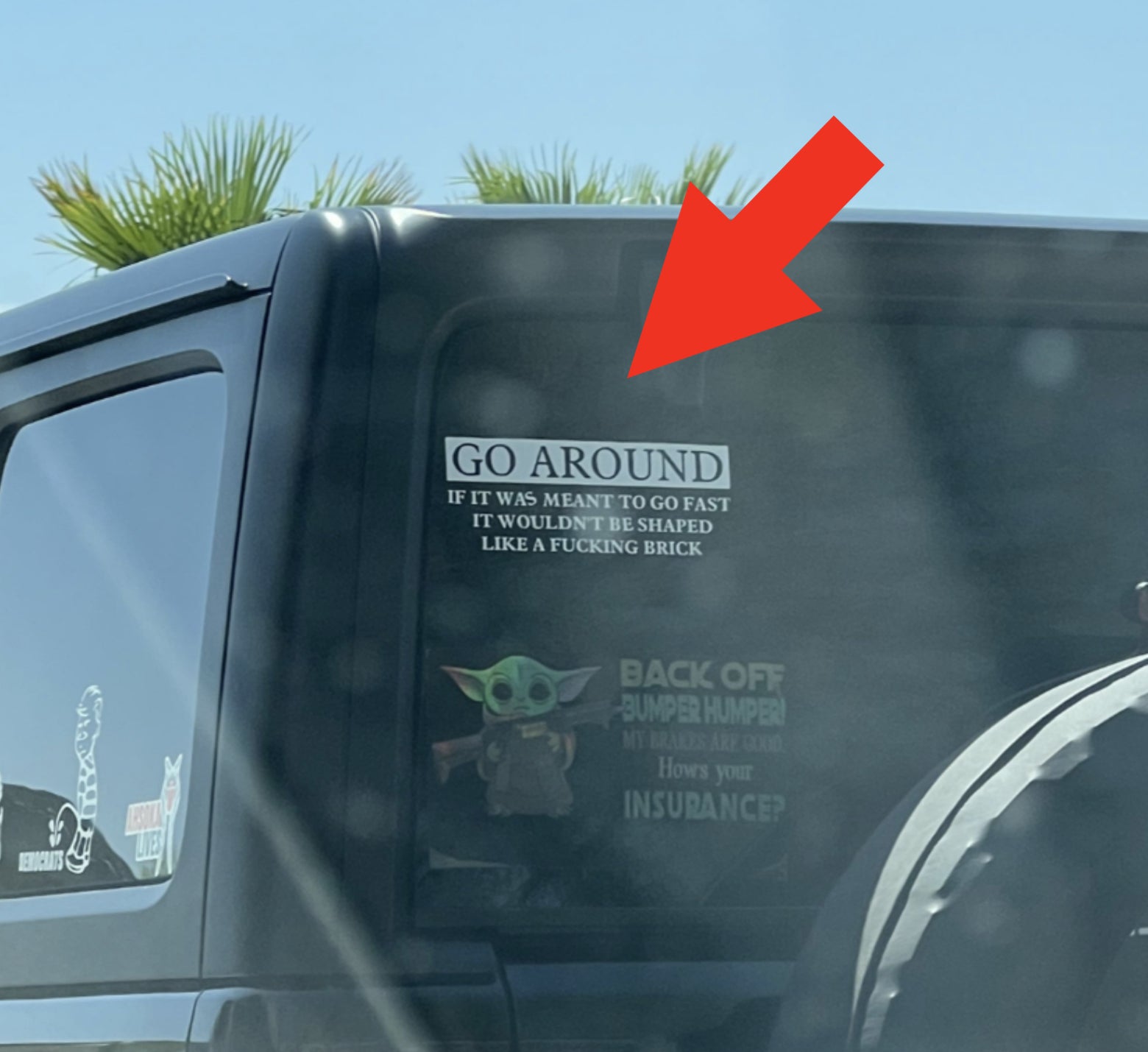 Jeep with stickers: "GO AROUND" with a long phrase; "BACK OFF BUMPER HUMPER"; Baby Yoda and Ahsoka images; text about car insurance