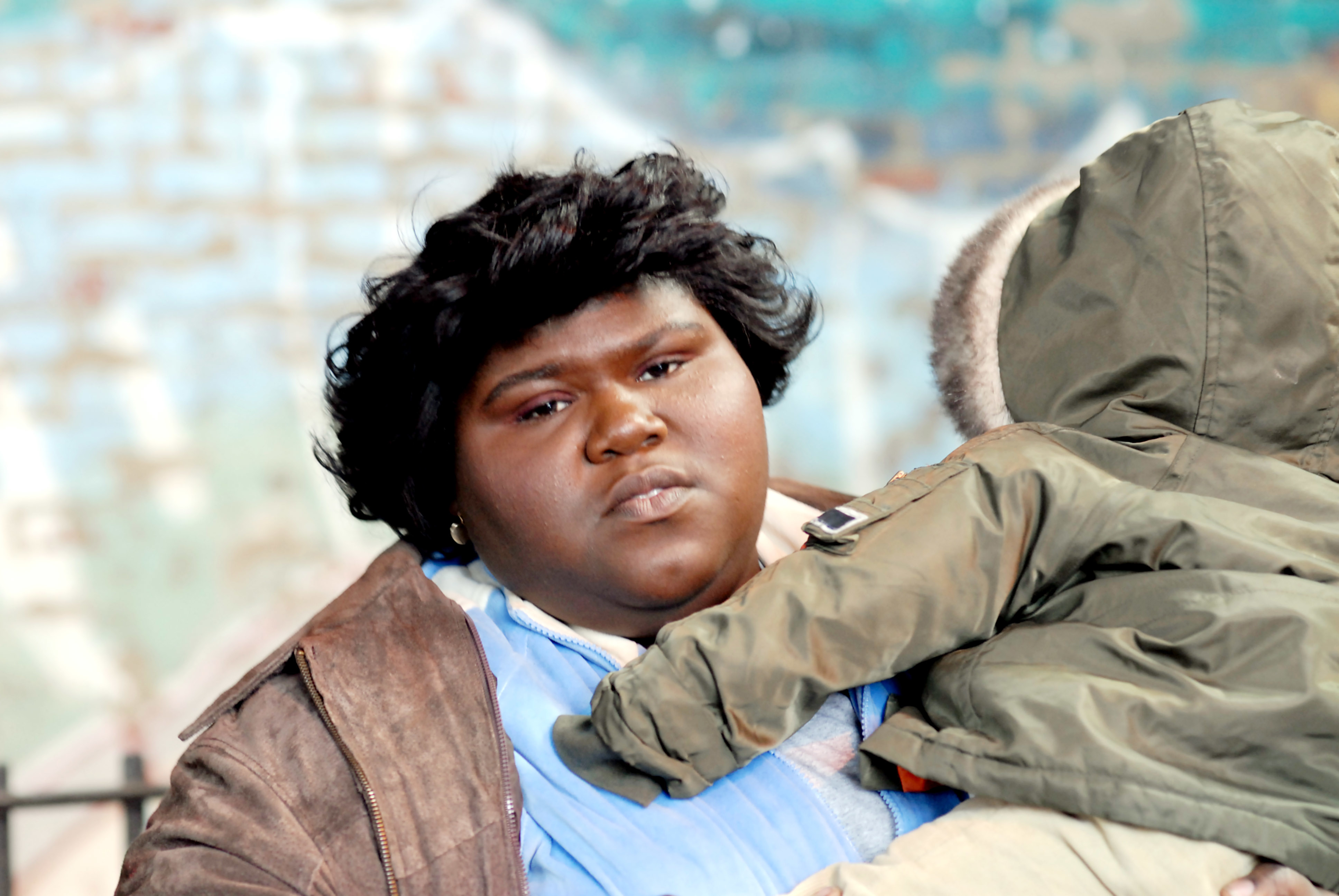 Gabourey Sidibe holds a child wearing a hooded jacket