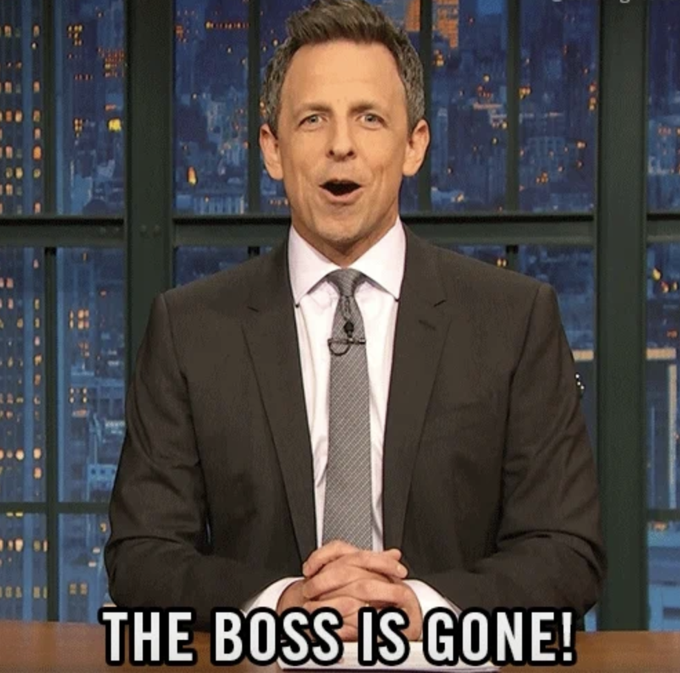 Seth Meyers sits at a news desk on a studio set