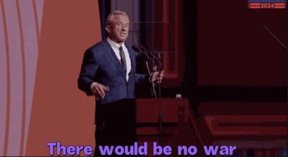 Robert F. Kennedy Jr., wearing a suit, stands at a podium during a speech with the text "There would be no war" displayed at the bottom