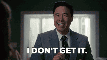 Randall Park, wearing a suit with a tie, smiles and says &quot;I DON'T GET IT.&quot;