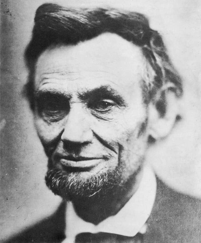 A historical portrait of Abraham Lincoln with a beard, wearing a suit and bow tie