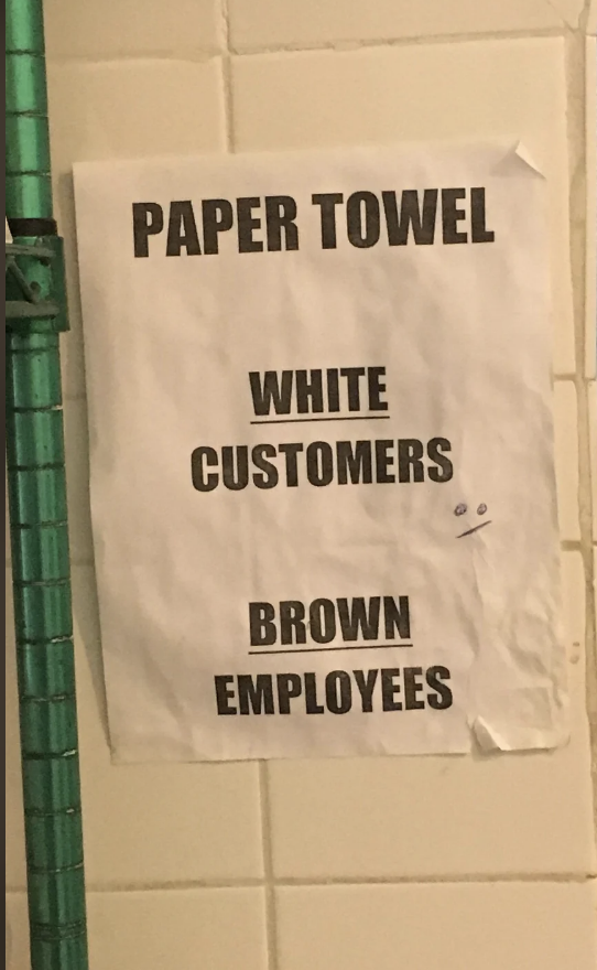Sign with the text: "PAPER TOWEL. WHITE CUSTOMERS. BROWN EMPLOYEES." with a small drawn face on the right