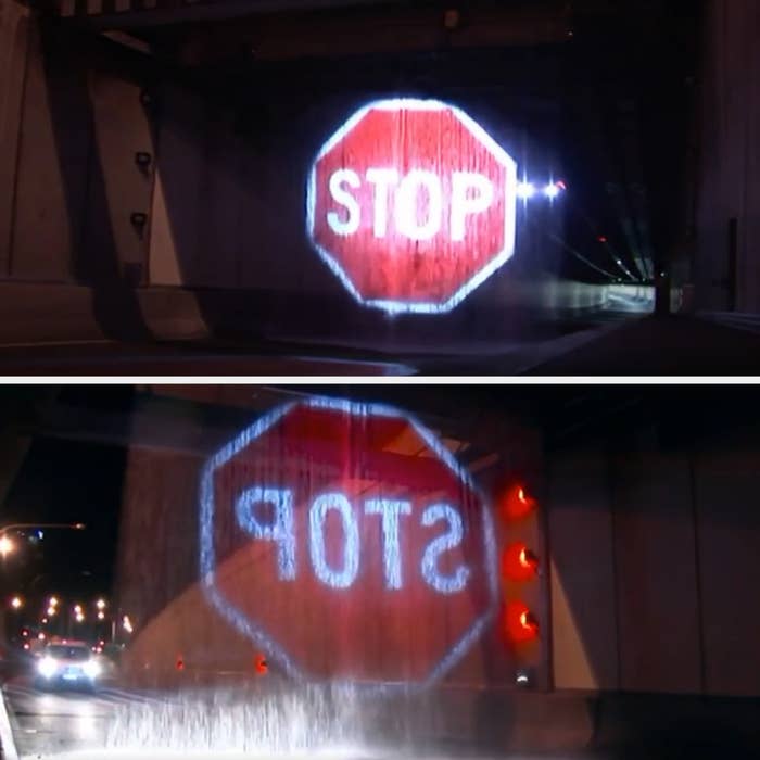 Water curtain projection of a stop sign in a tunnel at night, aimed at directing traffic