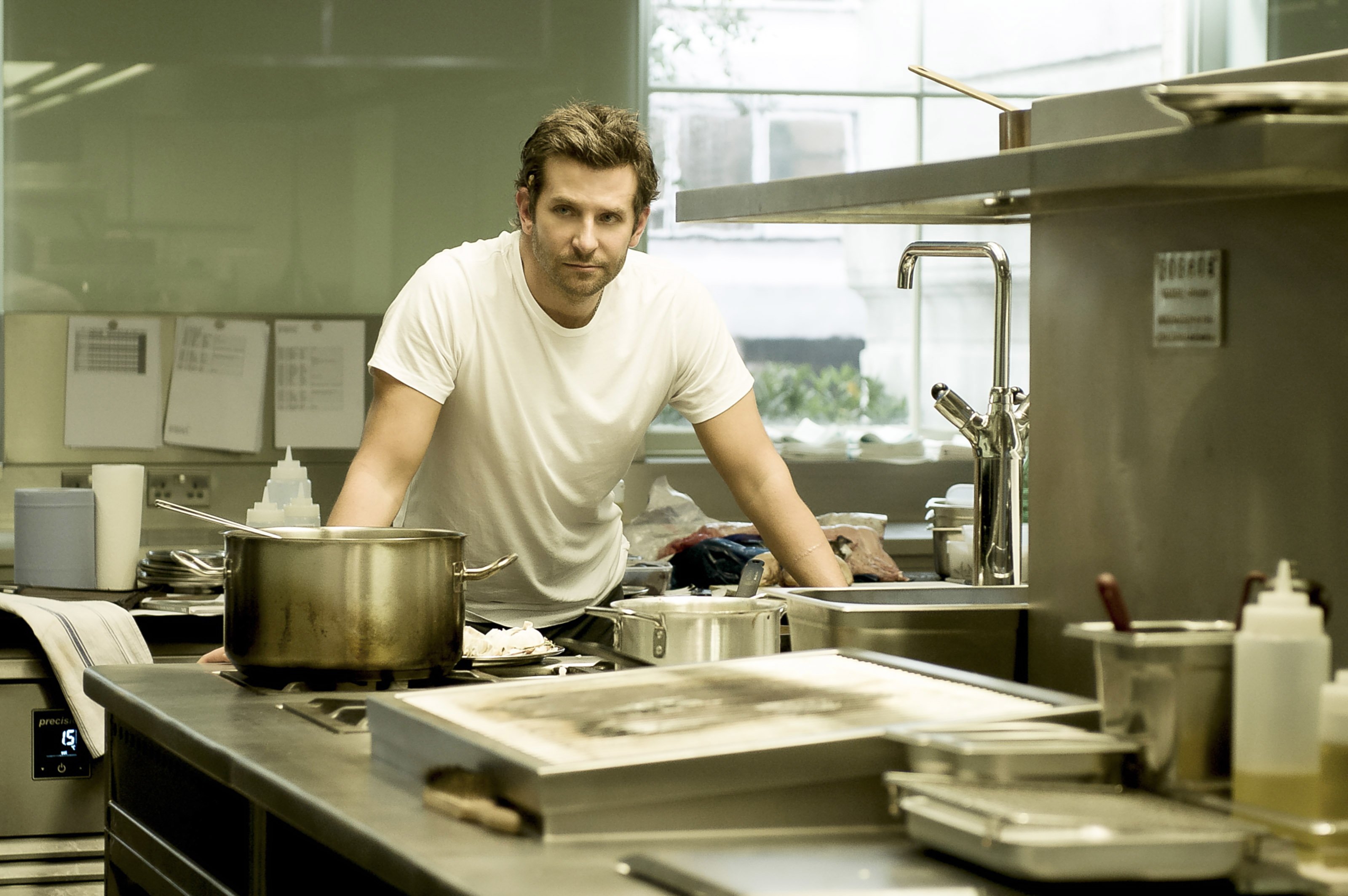 Bradley Cooper in a kitchen, wearing a white tee in &quot;Burnt&quot;