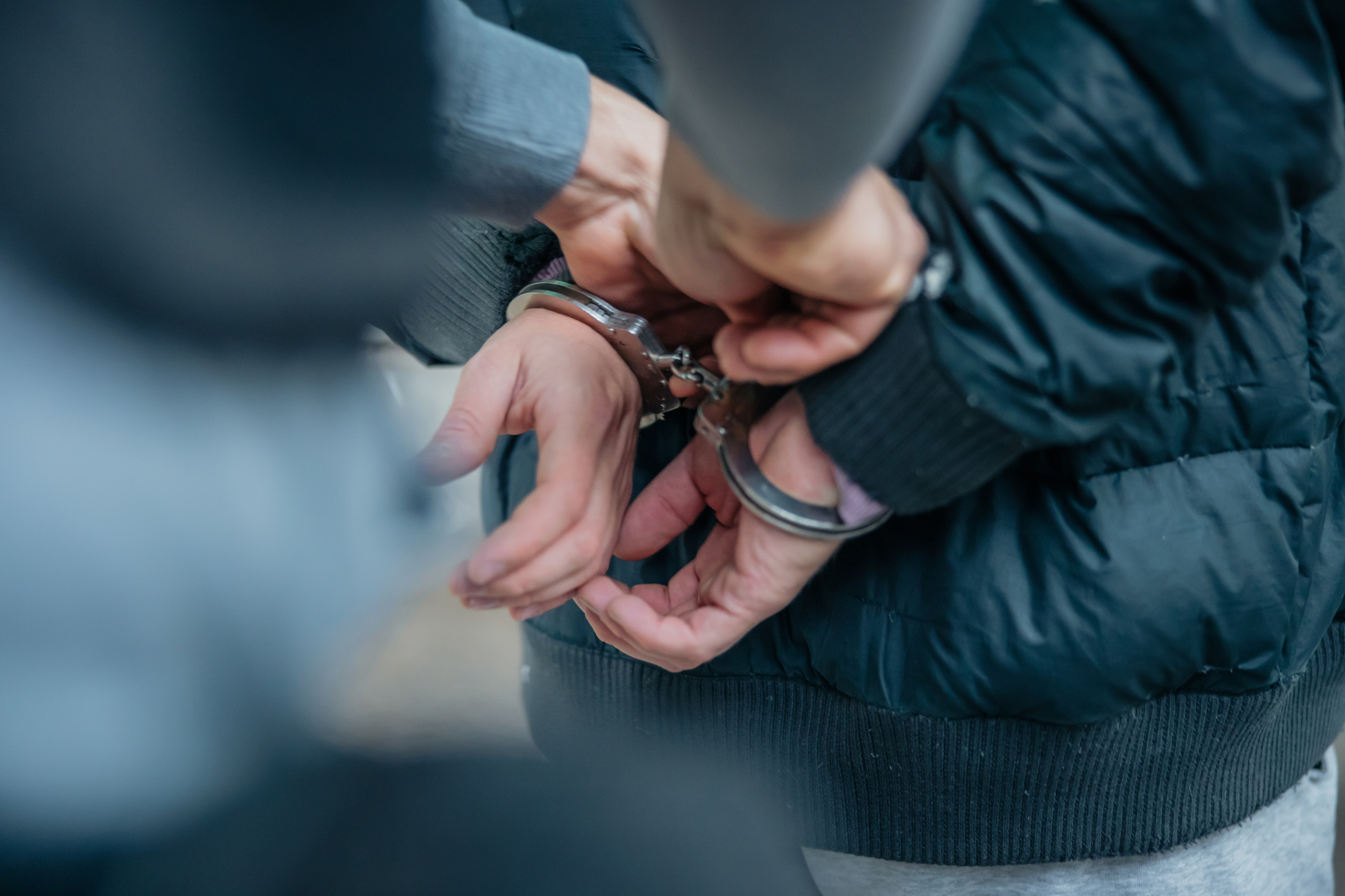 Close-up of a person's hands being handcuffed by another individual. The article is categorized as Sex & Love
