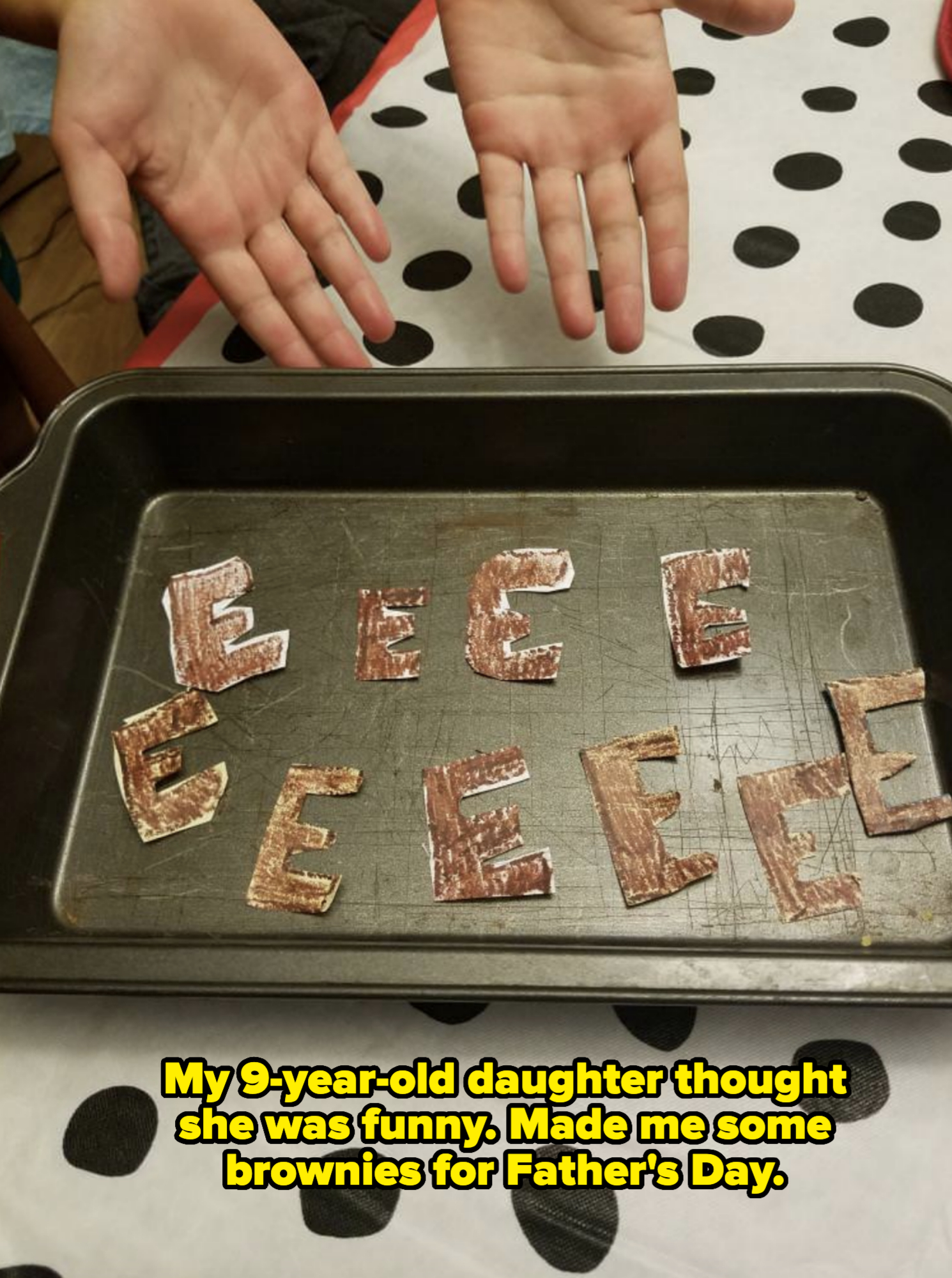 A baking tray with pieces of paper cut into the letter "E" and colored brown captioned "my 9-year old thought she was funny, made me some brownies for father's day"