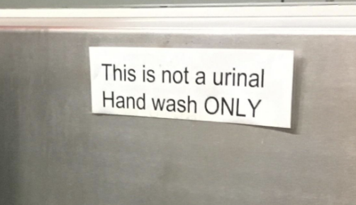 Sign on a metal surface reads, "This is not a urinal. Hand wash ONLY."