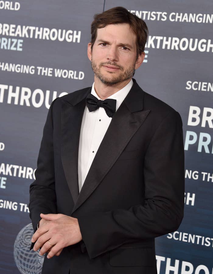 Ashton Kutcher at the Breakthrough Prize red carpet event, wearing a tuxedo with a bowtie