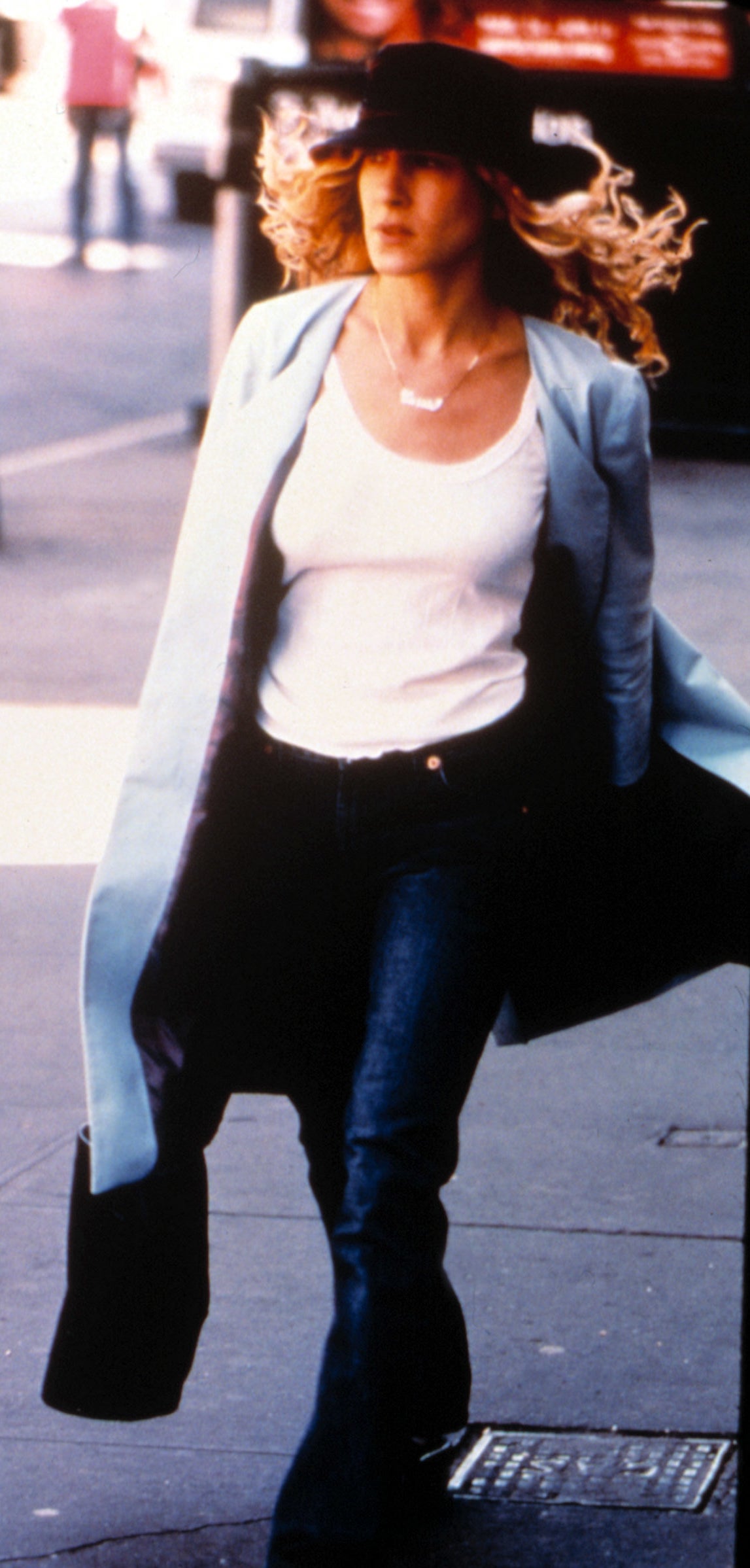 Sarah Jessica Parker walking on a sidewalk in "Sex and the City"