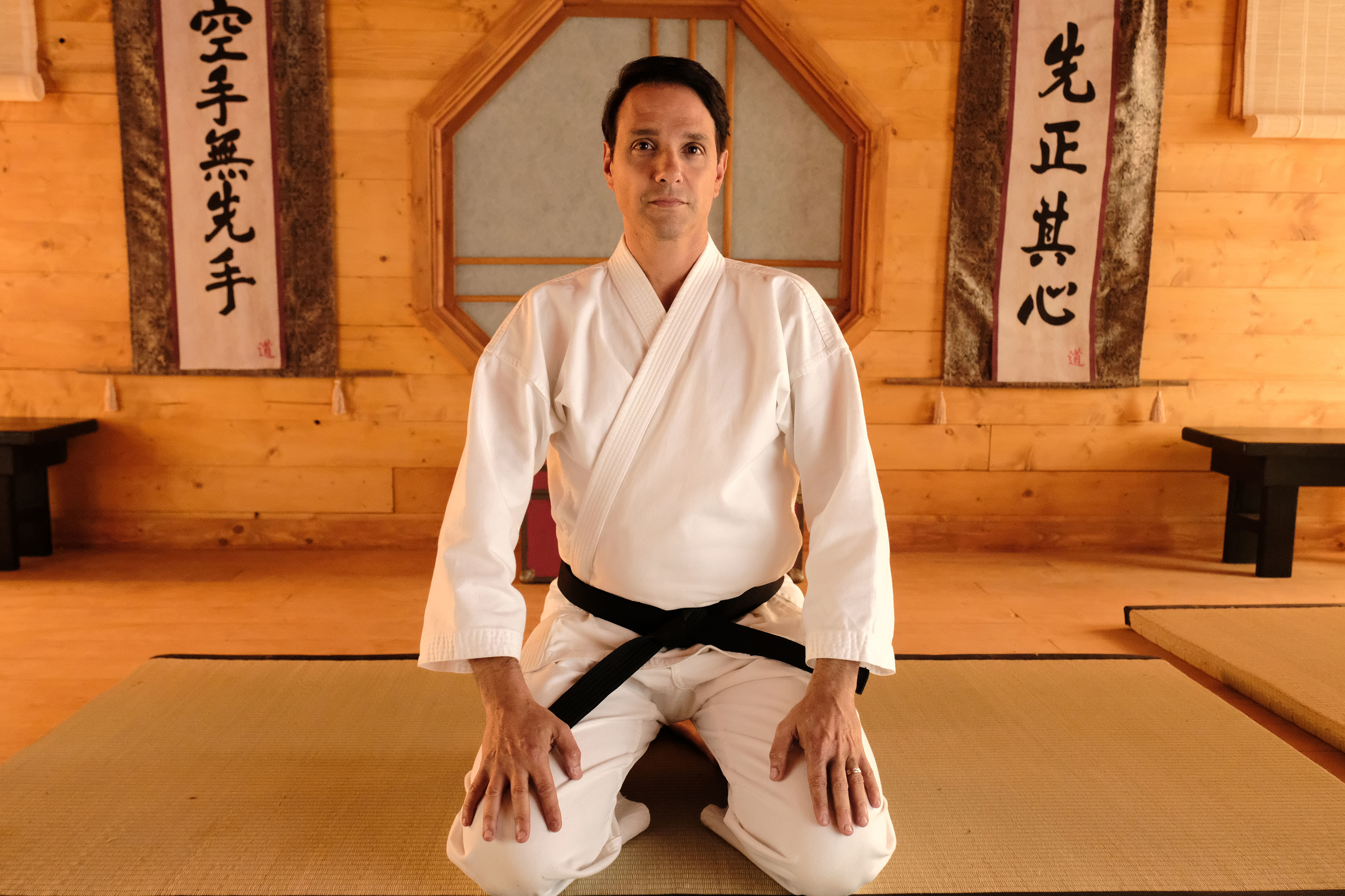 Ralph Macchio in a karate uniform with a black belt in "Cobra Kai"