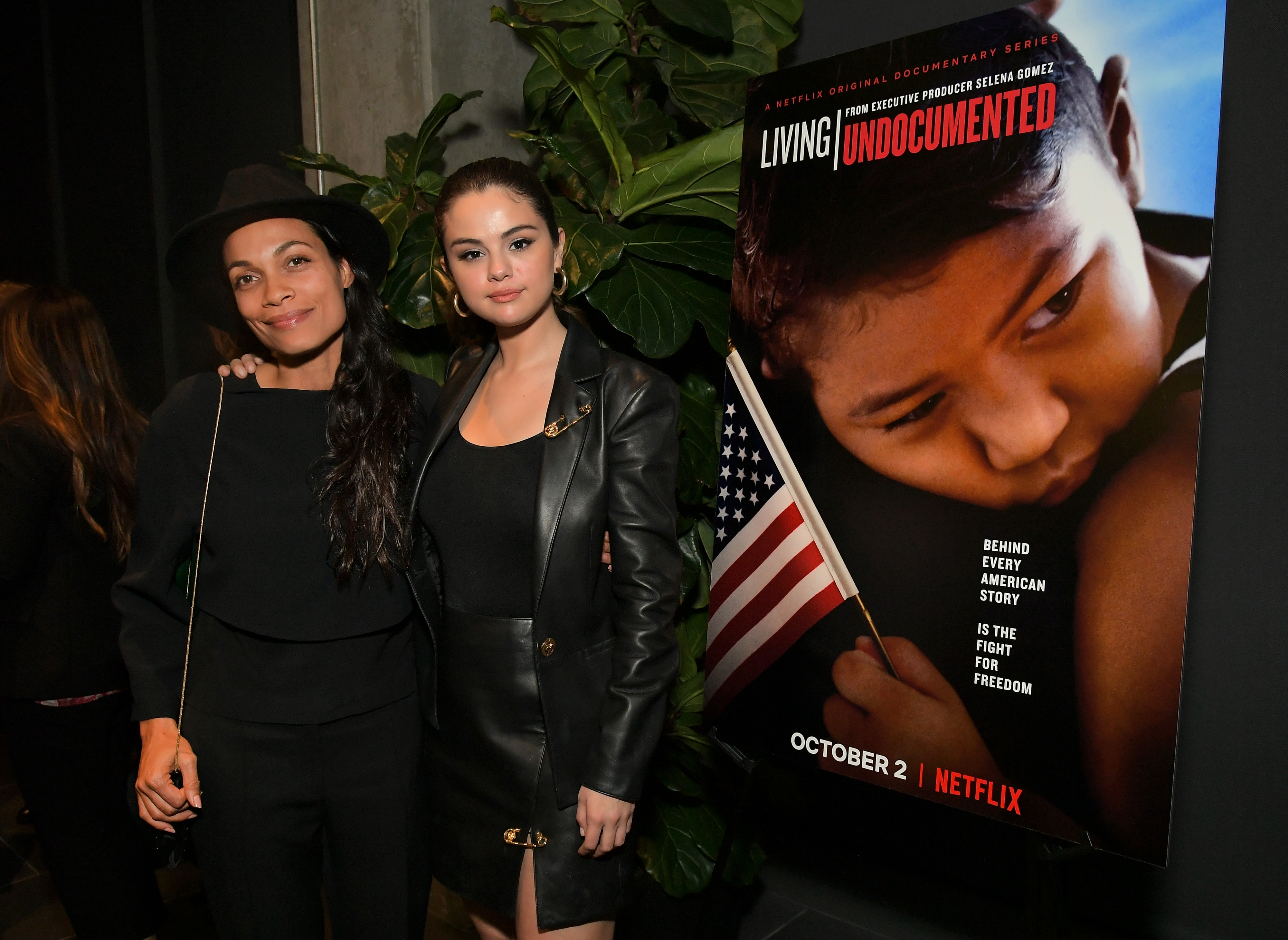 Rosario Dawson and Selena Gomez pose next to a &#x27;Living Undocumented&#x27; poster at a Netflix event