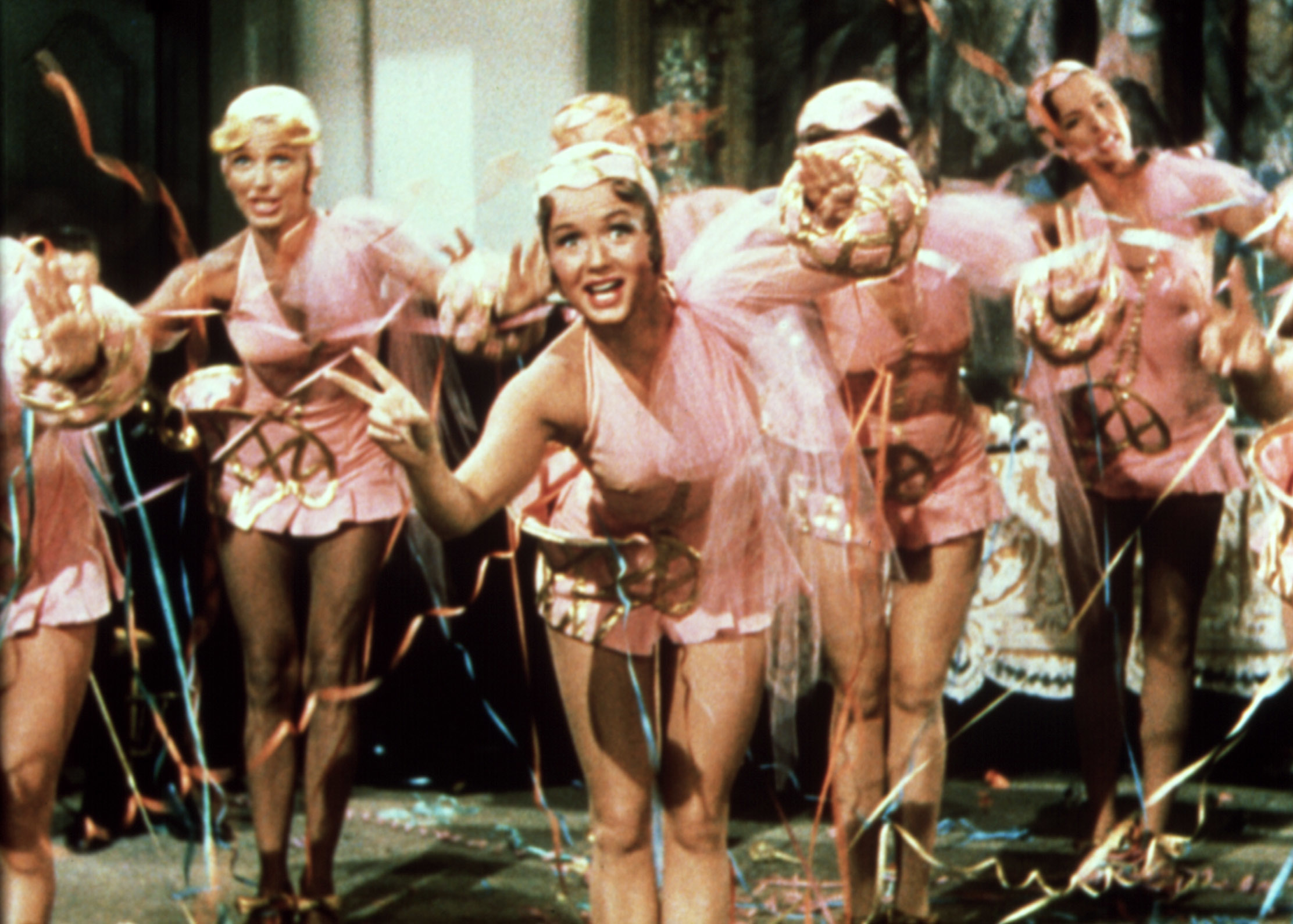 Image from the movie &quot;Singin' in the Rain&quot; Debbie Reynold, and chorus girls dressed in elaborate dance costumes performing