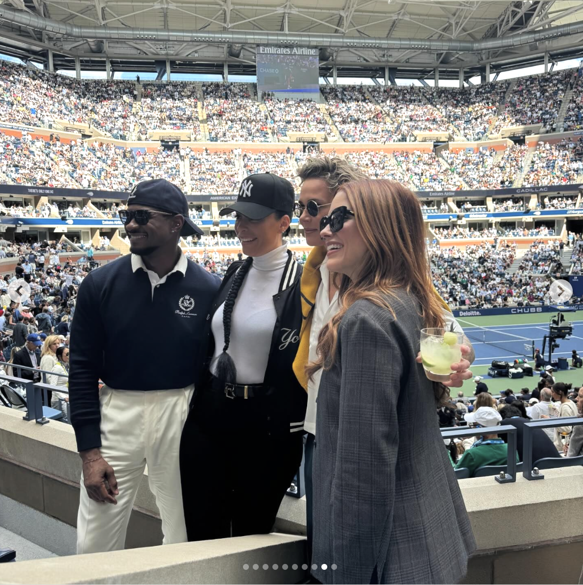 Group photo of Michael K. Williams, Alicia Keys, Swizz Beatz, and Jessica Chastain at a tennis match in a crowded stadium