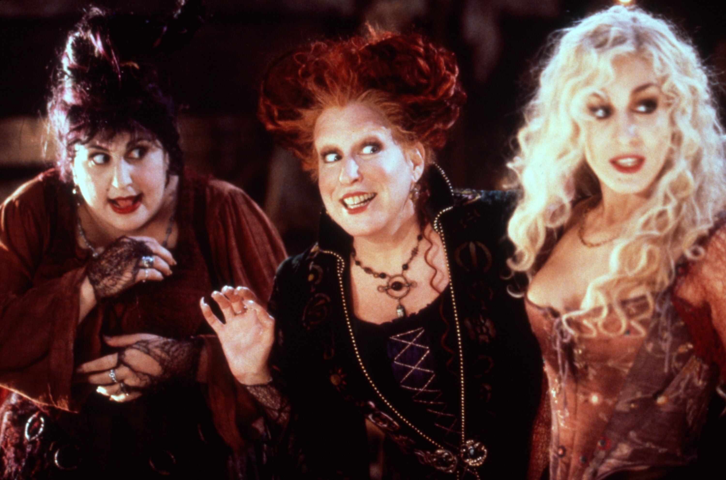Kathy Najimy, Bette Midler, and Sarah Jessica Parker in witch costumes in a scene from the movie "Hocus Pocus"