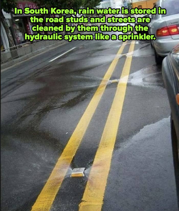 A car is stopped on a rainy street next to a yellow line divider that veers off into an apparent puddle, creating an oddly distorted road marking