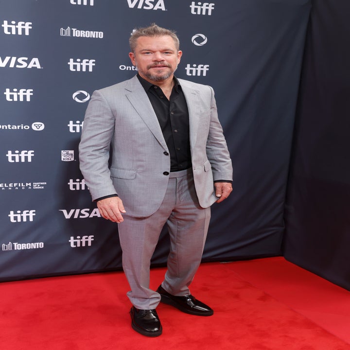 Matt Damon on the red carpet wearing a light gray suit with a black shirt at the Toronto International Film Festival (TIFF) event