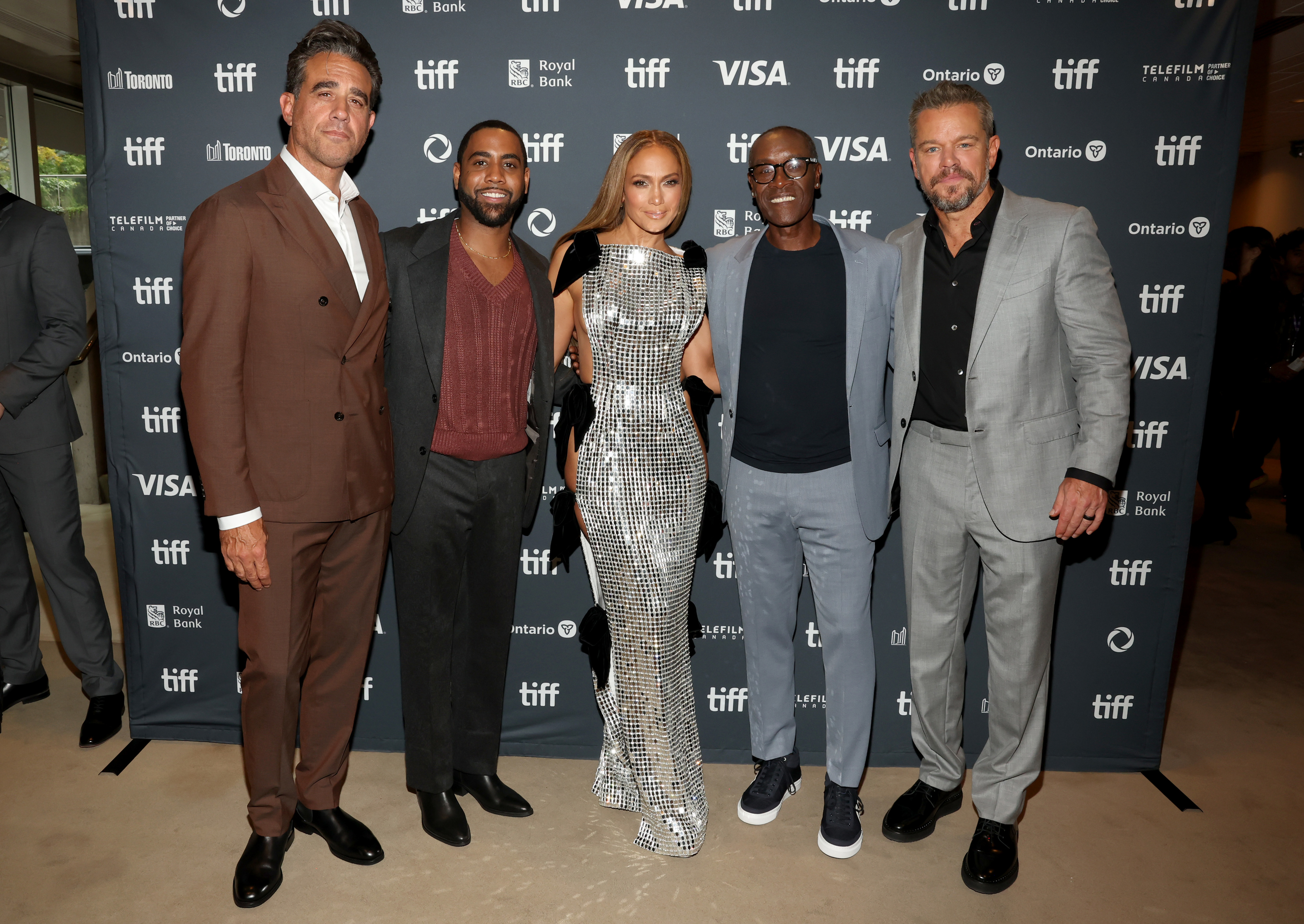 Patrick Whitesell, Caleb McLaughlin, Jennifer Lopez, Leslie Odom Jr., and Ben Affleck on the TIFF red carpet. Lopez is in a sparkling fitted dress