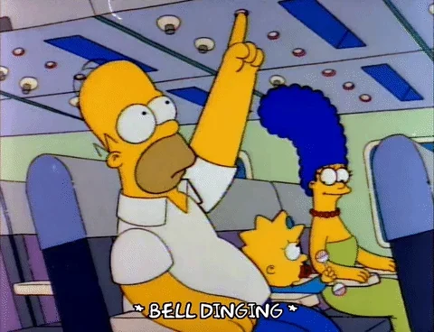 Homer Simpson presses button while seated on an airplane, alongside Marge and Lisa Simpson. Caption reads &quot;*BELL DINGING*&quot;