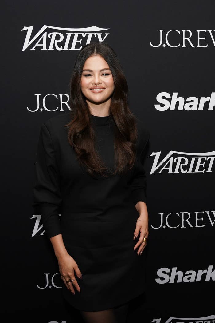 Selena Gomez smiles at a Variety event, wearing a stylish black long sleeve dress
