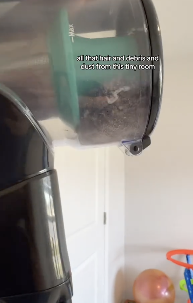 A vacuum cleaner canister filled with hair and debris