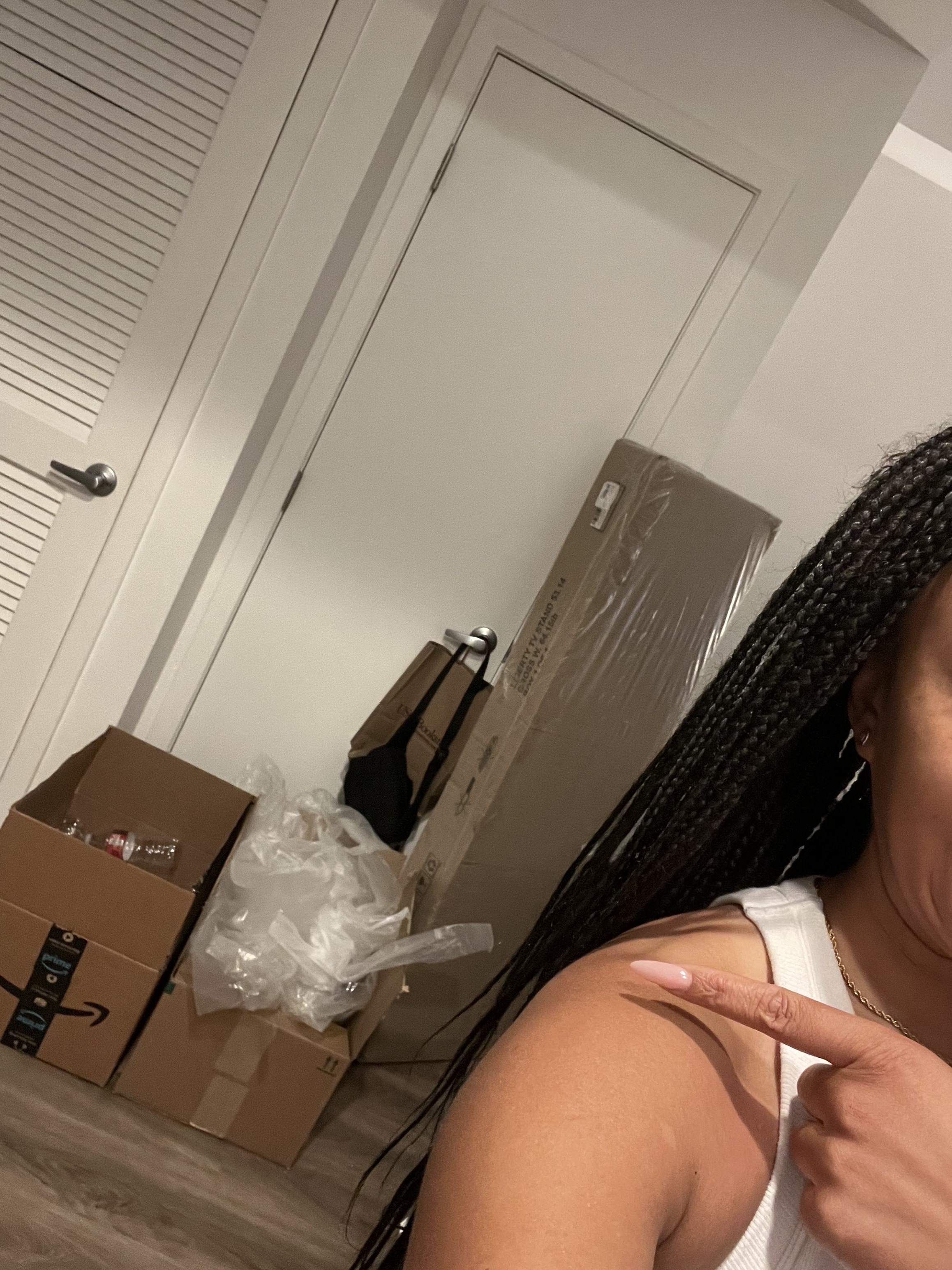 Ashley points to an assortment of cardboard boxes