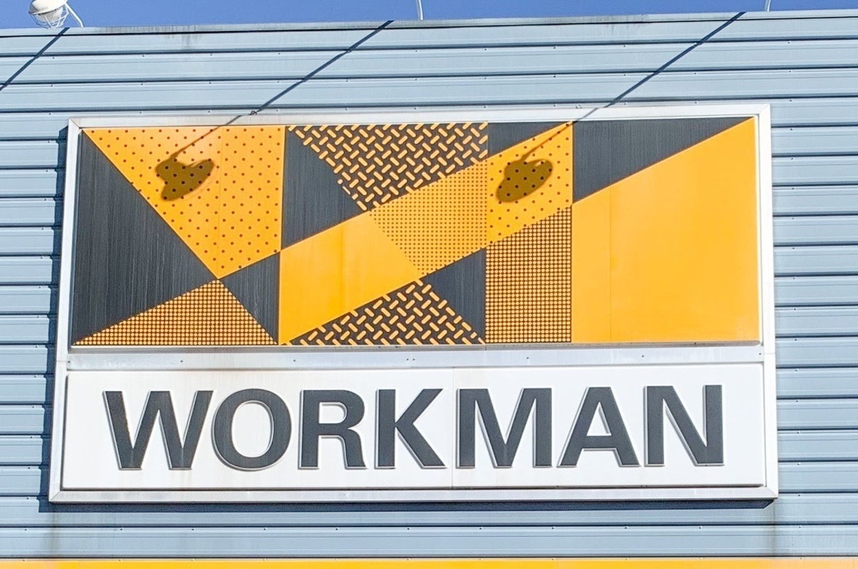 Large sign on a building reads "WORKMAN" with an abstract geometric design above it