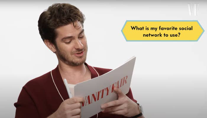 Andrew Garfield, in casual attire, reading from a Vanity Fair card with the text, &quot;What is my favorite social network to use?&quot;